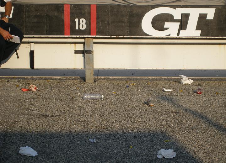 used lugnuts and empty bottles in the used and empty pit